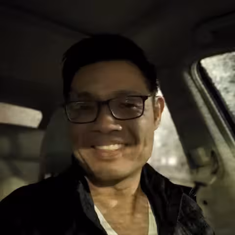 Man smiling in car.